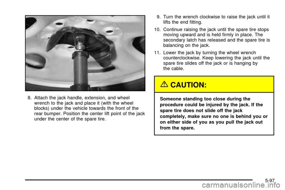 CHEVROLET SUBURBAN 2003 9.G Owners Manual 8. Attach the jack handle, extension, and wheel
wrench to the jack and place it (with the wheel
blocks) under the vehicle towards the front of the
rear bumper. Position the center lift point of the ja